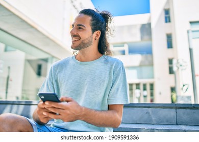 Young Hispanic Man Smiling Happy Using Smartphone At City.