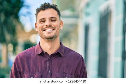 Young hispanic man smiling happy standing at the city. - Powered by Shutterstock