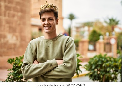 Young Hispanic Man Smiling Happy Wearing Gold King Crown At The City.