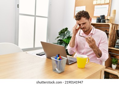 Young Hispanic Man Stressed Working At Office