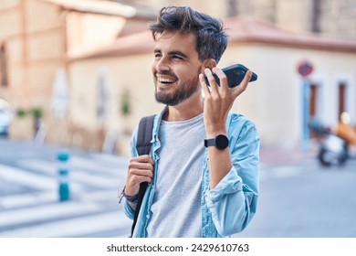 Young hispanic man student smiling confident listening voice message by smartphone at street - Powered by Shutterstock