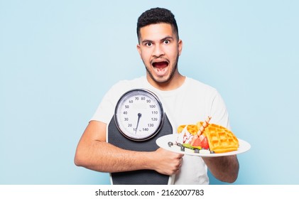 Young Hispanic Man Surprised Expression And Dieting Concept