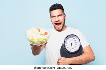 Young Hispanic Man Surprised Expression And Dieting Concept