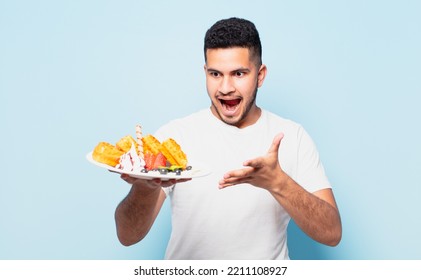 Young Hispanic Man Surprised Expression. Waffles Concept