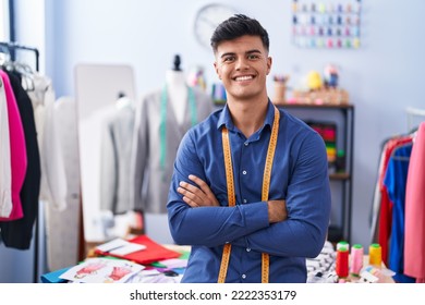 Young hispanic man tailor smiling confident standing with arms crossed gesture at clothing factory - Shutterstock ID 2222353179