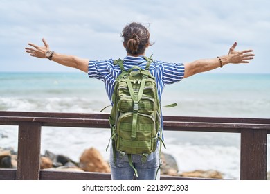 Young Hispanic Man Tourist Wearing Backpack Standing With Arms Open At Seaside