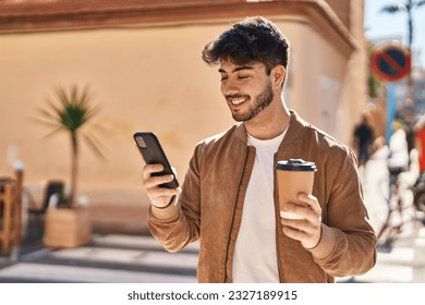 Young hispanic man using smartphone drinking coffee at street - Powered by Shutterstock