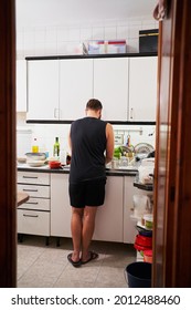 Young Hispanic Man Washing Dishes. Everyday Chores