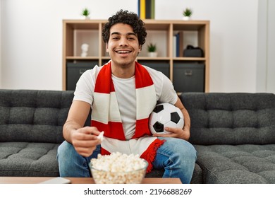 Young Hispanic Man Watching Soccer Match And Supporting Team At Home.