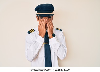 Young Hispanic Man Wearing Airplane Pilot Uniform Rubbing Eyes For Fatigue And Headache, Sleepy And Tired Expression. Vision Problem 