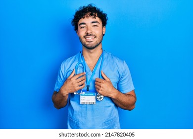 Young Hispanic Man Wearing Blue Male Nurse Uniform Smiling With A Happy And Cool Smile On Face. Showing Teeth. 