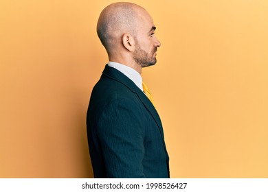 Young Hispanic Man Wearing Business Suit And Tie Looking To Side, Relax Profile Pose With Natural Face With Confident Smile. 