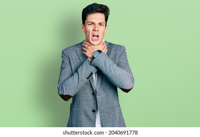 Young hispanic man wearing business clothes shouting suffocate because painful strangle. health problem. asphyxiate and suicide concept. 