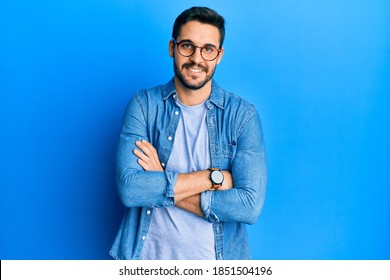 Young Hispanic Man Wearing Casual Clothes And Glasses Happy Face Smiling With Crossed Arms Looking At The Camera. Positive Person. 