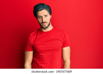 Young Hispanic Man Wearing Casual Red T Shirt Depressed And Worry For Distress, Crying Angry And Afraid. Sad Expression. 