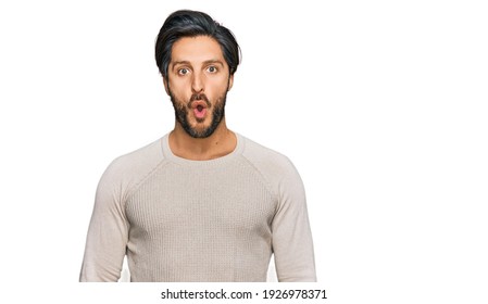 Young Hispanic Man Wearing Casual Clothes Scared And Amazed With Open Mouth For Surprise, Disbelief Face 