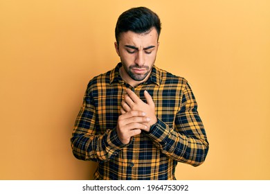 Young Hispanic Man Wearing Casual Clothes Suffering Pain On Hands And Fingers, Arthritis Inflammation 