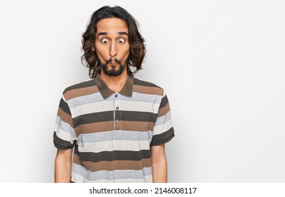 Young Hispanic Man Wearing Casual Clothes Making Fish Face With Lips, Crazy And Comical Gesture. Funny Expression. 