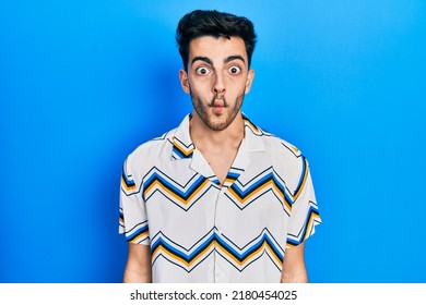 Young Hispanic Man Wearing Casual Clothes Making Fish Face With Lips, And Comical Gesture. Funny Expression. 