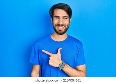 Young Hispanic Man Wearing Casual Clothes Cheerful With A Smile On Face Pointing With Hand And Finger Up To The Side With Happy And Natural Expression 