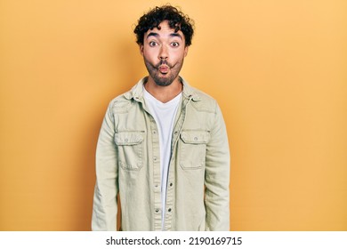 Young Hispanic Man Wearing Casual Clothes Making Fish Face With Lips, Crazy And Comical Gesture. Funny Expression. 