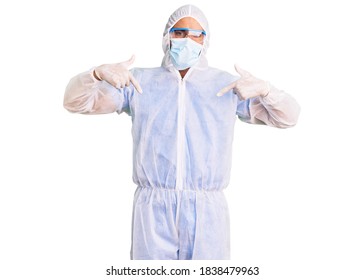 Young hispanic man wearing doctor protection coronavirus uniform and medical mask looking confident with smile on face, pointing oneself with fingers proud and happy.  - Shutterstock ID 1838479963