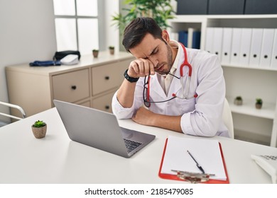 Young Hispanic Man Wearing Doctor Uniform Stressed Working At Clinic