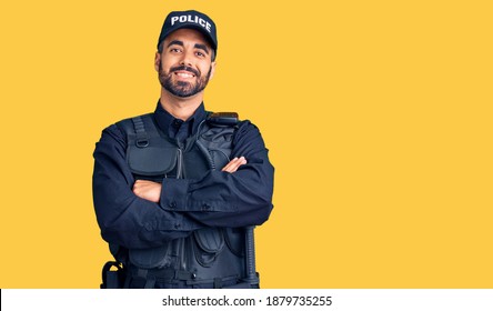 Young Hispanic Man Wearing Police Uniform Happy Face Smiling With Crossed Arms Looking At The Camera. Positive Person. 