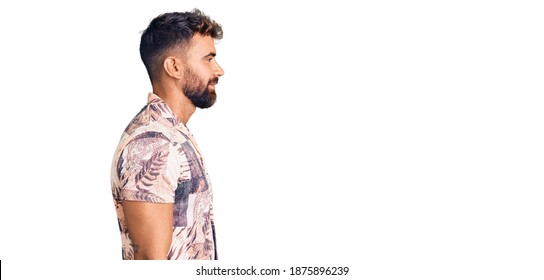 Young Hispanic Man Wearing Summer Clothes Looking To Side, Relax Profile Pose With Natural Face With Confident Smile. 