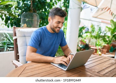 Young Hispanic Man Working Using Laptop At The Terrace.