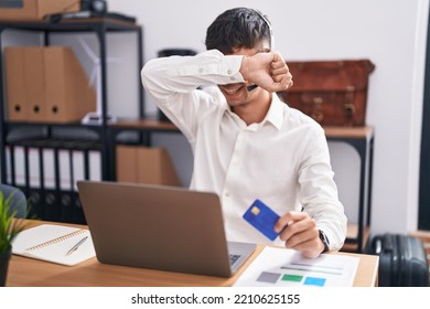 Young Hispanic Man Working Using Computer Laptop Holding Credit Card Smiling Cheerful Playing Peek A Boo With Hands Showing Face. Surprised And Exited 