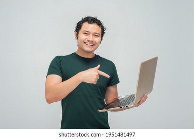 Young hispanic mexican with laptop in arms - Shutterstock ID 1951481497