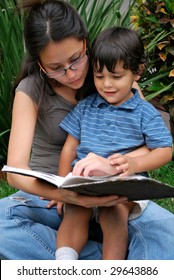 Young Hispanic Mother And Child Reading A Story