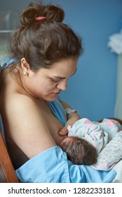 Young Hispanic Mother Woman With Newborn Breastfeeding 