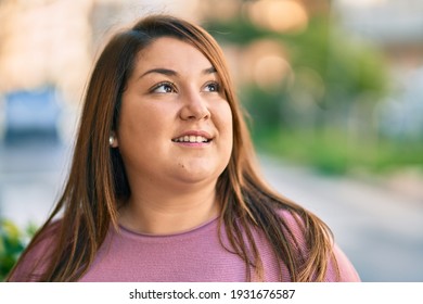 Young Hispanic Plus Size Woman Smiling Happy Standing At The Park.