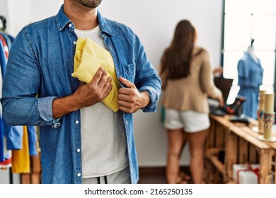 Young Hispanic Robber Man Stealing Shirt At Clothes Store.