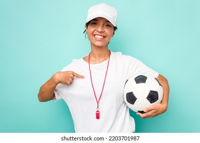 Young Hispanic Soccer Referee Woman Isolated On Blue Background Person Pointing By Hand To A Shirt Copy Space, Proud And Confident