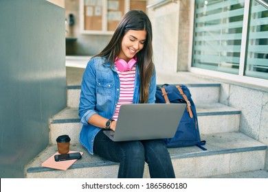 Young Hispanic Student Girl Smiling Happy Using Laptop At The University.