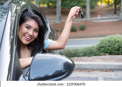 Young Hispanic Teenage Girl Learning To Drive A Car