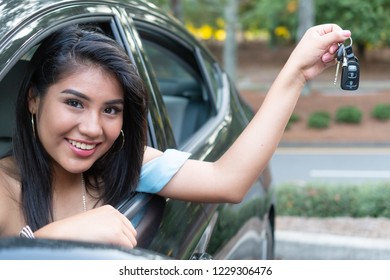 Young Hispanic Teenage Girl Learning To Drive A Car