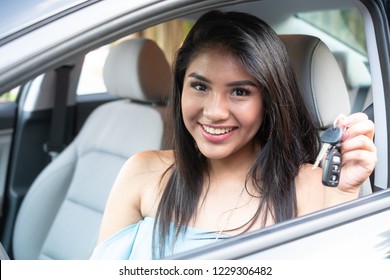 Young Hispanic Teenage Girl Learning To Drive A Car