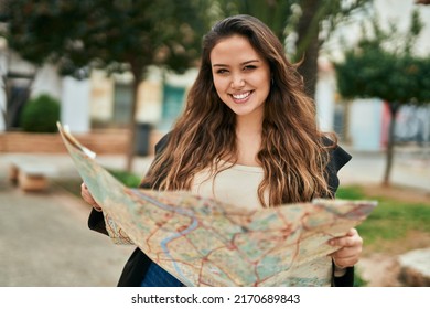 Young Hispanic Tourist Woman Holding Map At The City.