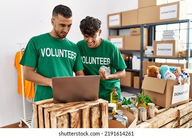 Young hispanic volunteers using laptop working at charity center. - Powered by Shutterstock