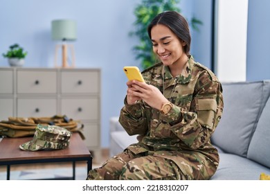 Young hispanic woman army soldier using smartphone at home - Powered by Shutterstock