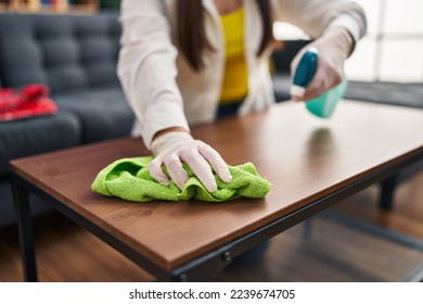 Young hispanic woman cleaning table at home - Shutterstock ID 2239674705