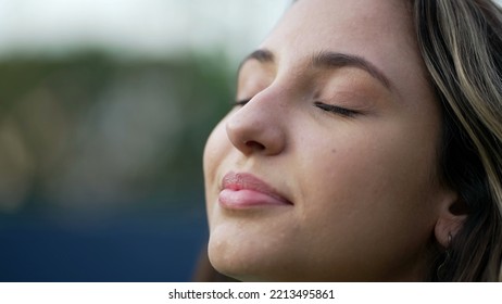 Young Hispanic Woman Closing Eyes In Meditation. Millennial 20s Girl Opening Eyes Smiling. Closeup Female Person Face