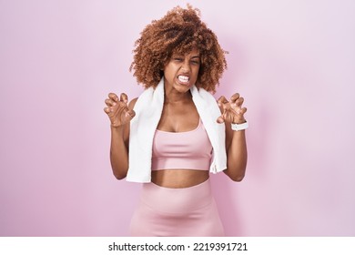 Young Hispanic Woman With Curly Hair Wearing Sportswear And Towel Smiling Funny Doing Claw Gesture As Cat, Aggressive And Sexy Expression 