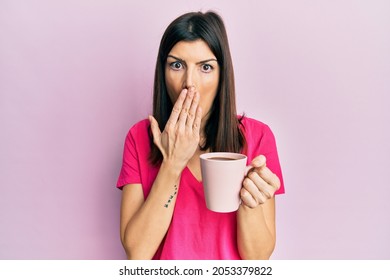 Young Hispanic Woman Drinking A Cup Of Coffee With Angry Face, Negative Sign Showing Dislike With Thumbs Down, Rejection Concept 