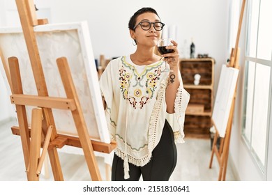 Young Hispanic Woman Drinking Wine Drawing At Art Studio