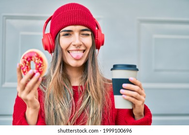 Young hispanic woman having breakfast using headphones at the city. - Powered by Shutterstock